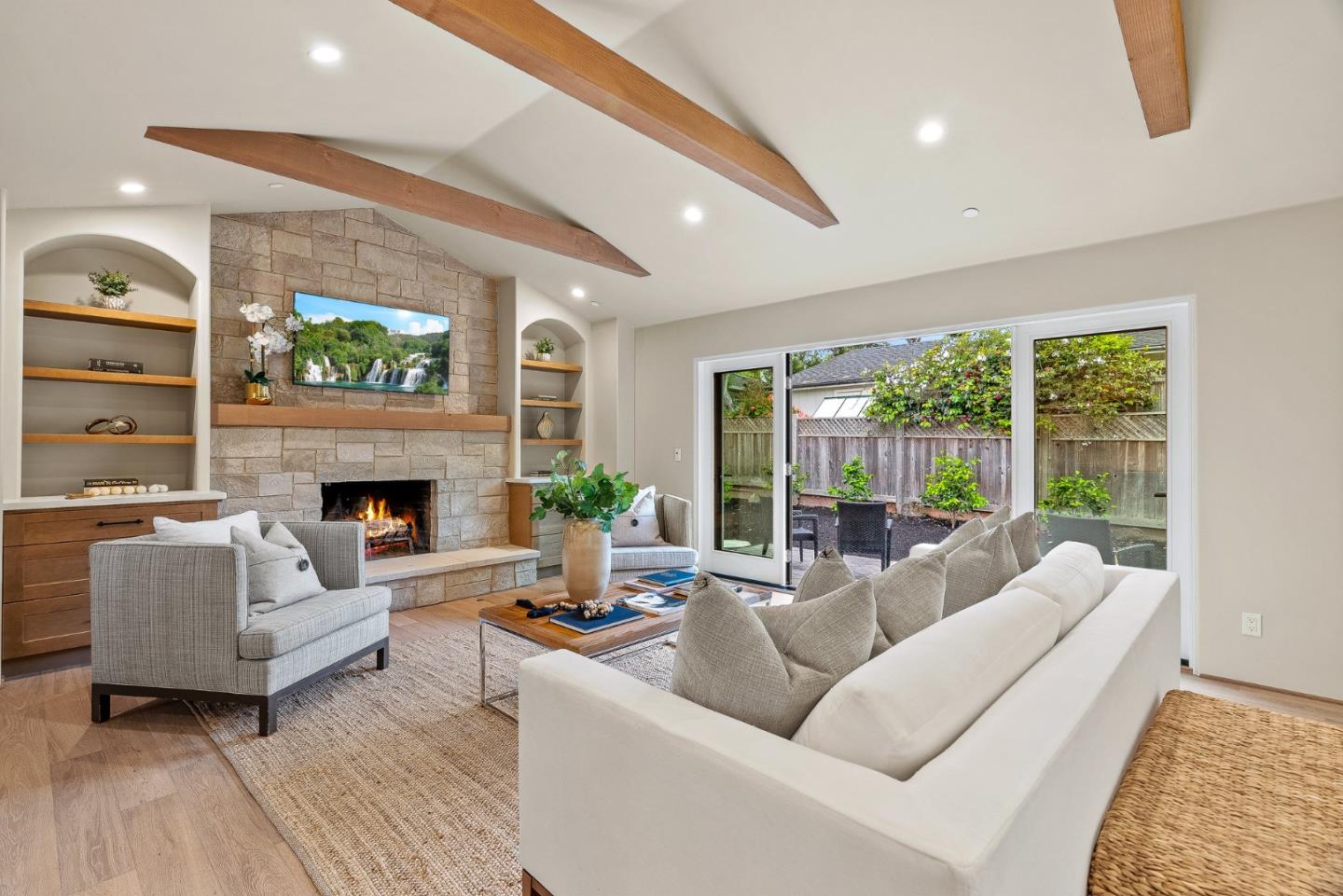 2869 Forest Lodge Road Pebble Beach, CA 93953 - Photo 5 of 34 a living room with furniture a large window and a fireplace