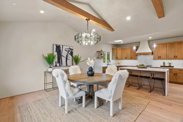 a view of a dining room with furniture and chandelier