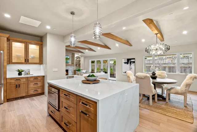 a kitchen with sink stove and wooden floor
