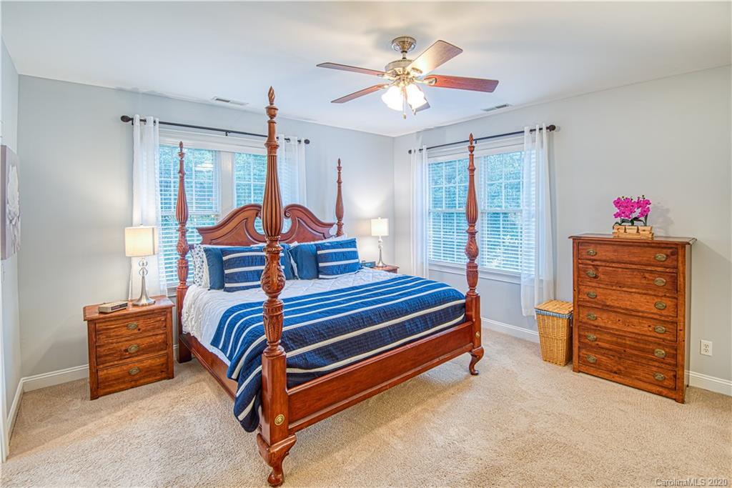 3224 Fifth Baxter Crossing Fort Mill, SC 29708 - Photo 18 of 41 a bedroom with a bed and a chandelier