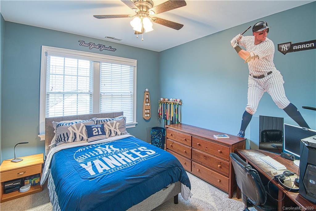 3224 Fifth Baxter Crossing Fort Mill, SC 29708 - Photo 22 of 41 a bedroom with a bed and a chandelier
