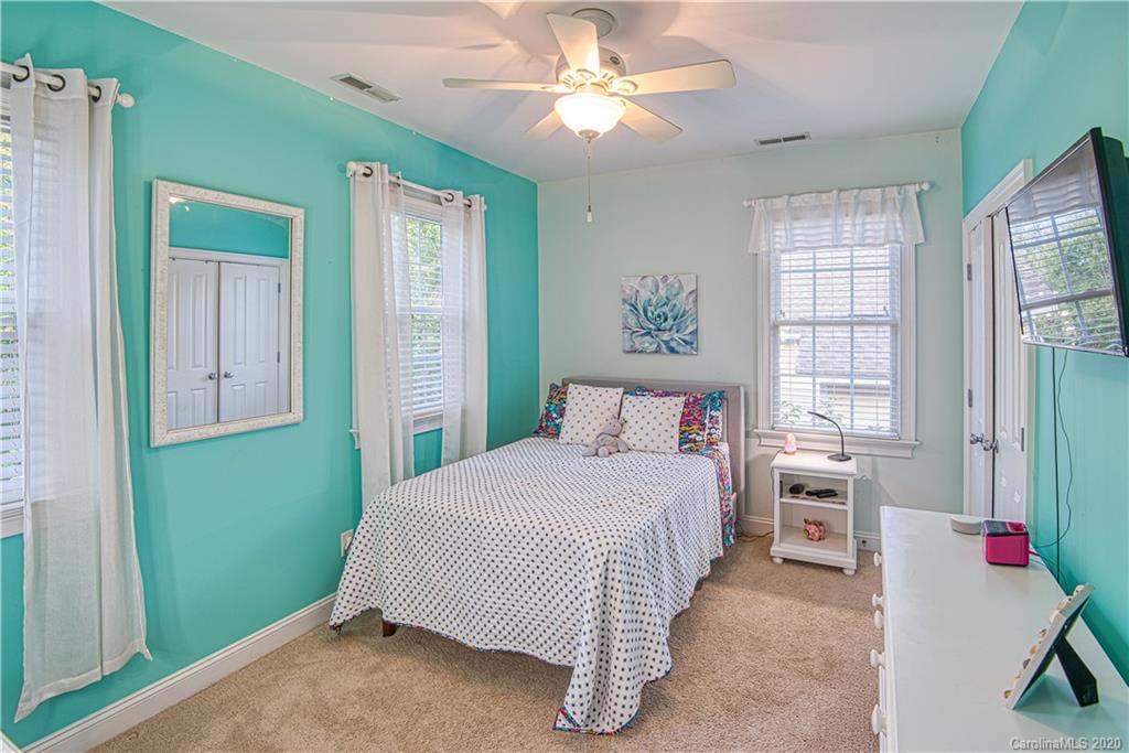 3224 Fifth Baxter Crossing Fort Mill, SC 29708 - Photo 23 of 41 a bedroom with a bed and a chandelier