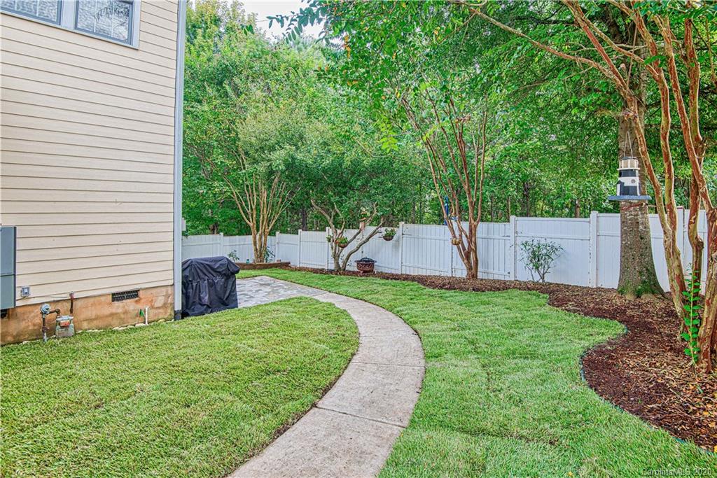 3224 Fifth Baxter Crossing Fort Mill, SC 29708 - Photo 26 of 41 a view of a backyard with a garden and trees