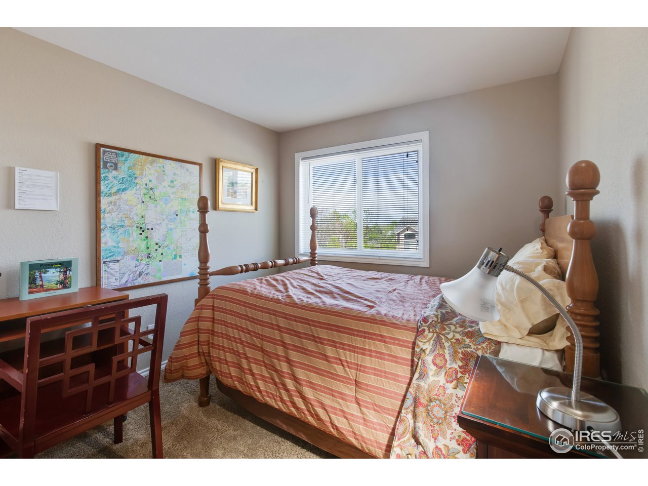 5635 Quarry Court Boulder, CO 80301 - Photo 12 of 28 a bedroom with a bed and wooden floor