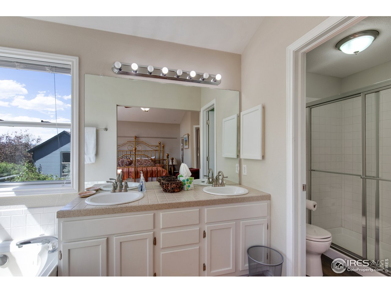 5635 Quarry Court Boulder, CO 80301 - Photo 14 of 28 a bathroom with a sink a toilet a mirror and shower