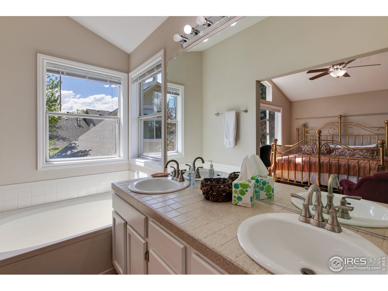 5635 Quarry Court Boulder, CO 80301 - Photo 16 of 28 a en suite bathroom with double vanity mirrors and window