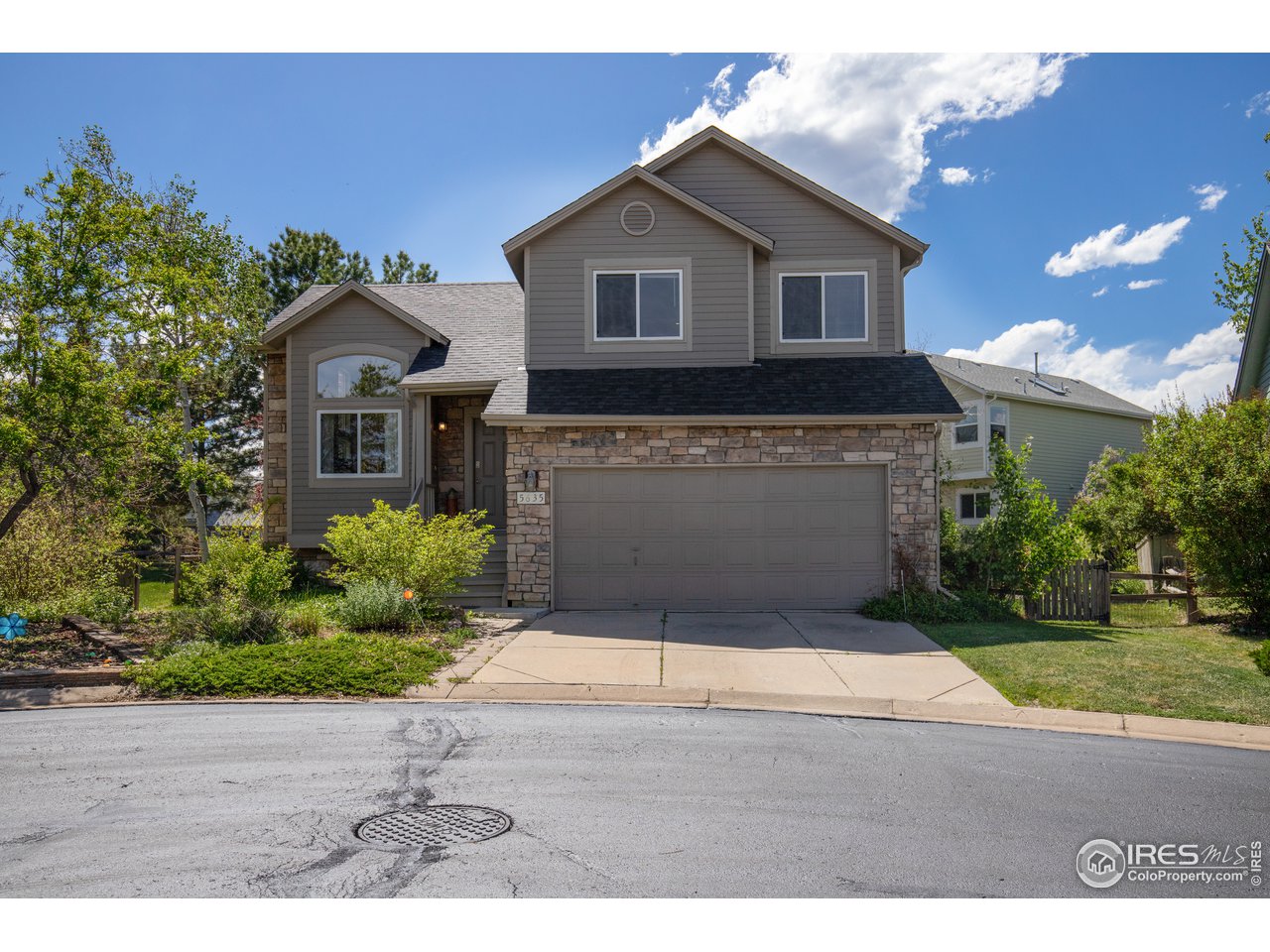 5635 Quarry Court Boulder, CO 80301 - Photo 2 of 28 a front view of a house with a yard and garage
