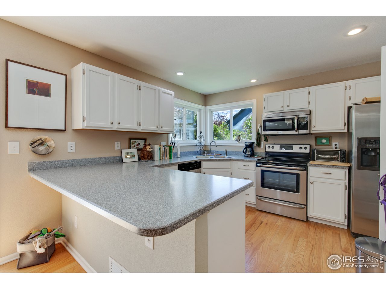 5635 Quarry Court Boulder, CO 80301 - Photo 8 of 28 a kitchen with stainless steel appliances granite countertop a sink stove and refrigerator