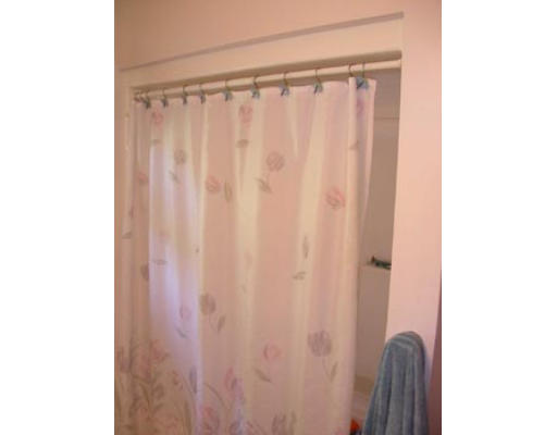 245 Perry Hill Road Acushnet, MA 02743 - Photo 16 of 20 a view of a bathroom with a shower curtain and a curtain
