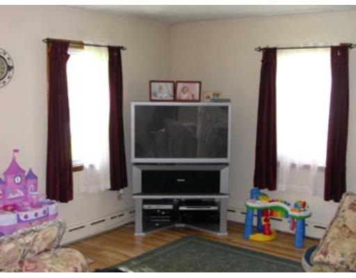 245 Perry Hill Road Acushnet, MA 02743 - Photo 5 of 20 a living room with furniture and a gate