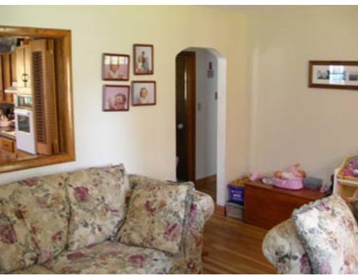 245 Perry Hill Road Acushnet, MA 02743 - Photo 8 of 20 a bedroom with a bed and wooden floor