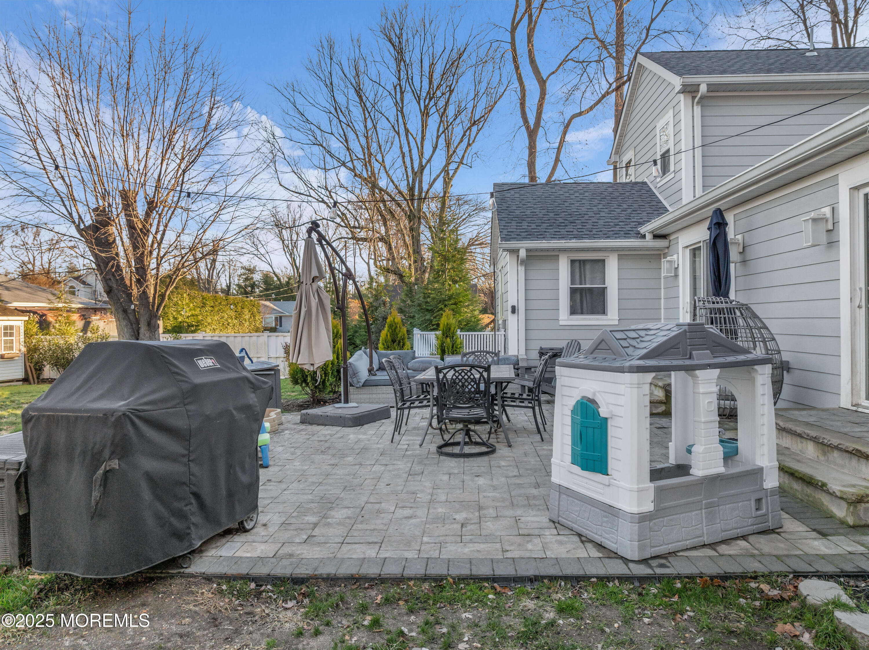 91 Sycamore Avenue Little Silver, NJ 07739 - Photo 42 of 52 a view of a house with patio chairs and a fire pit