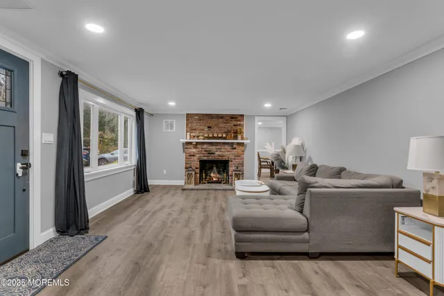 a living room with furniture a fireplace and a flat screen tv