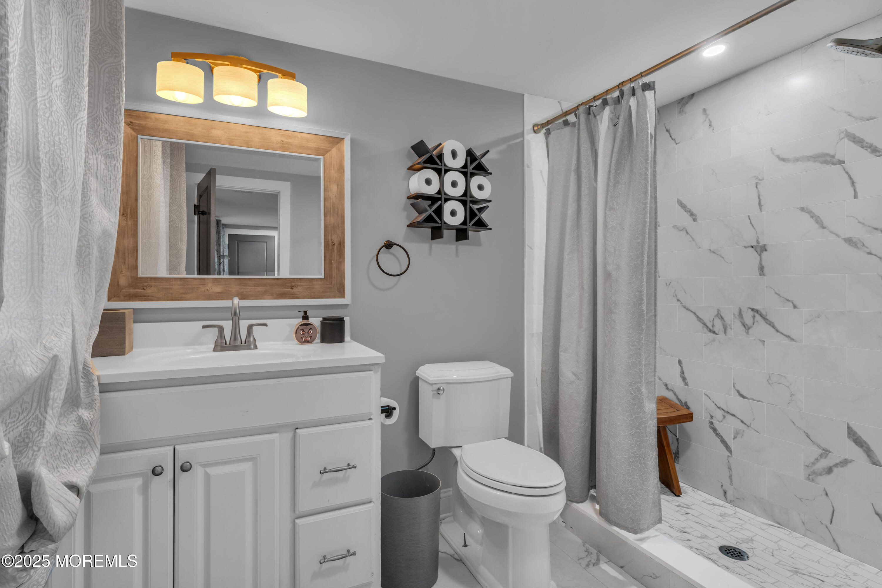 91 Sycamore Avenue Little Silver, NJ 07739 - Photo 9 of 52 a bathroom with a sink a toilet and shower