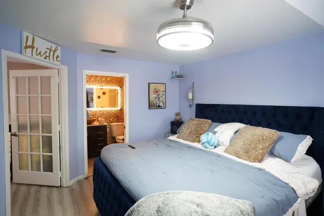a bedroom with a bed and a view of kitchen