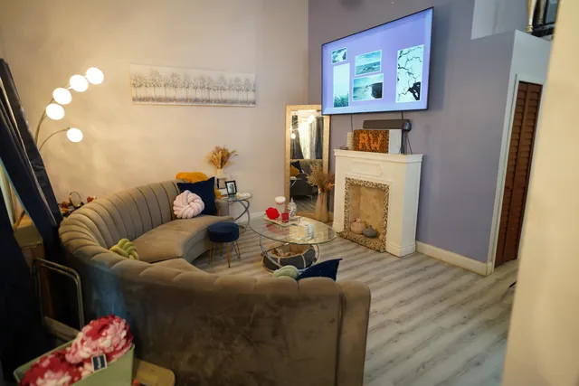 a living room with furniture and a fireplace