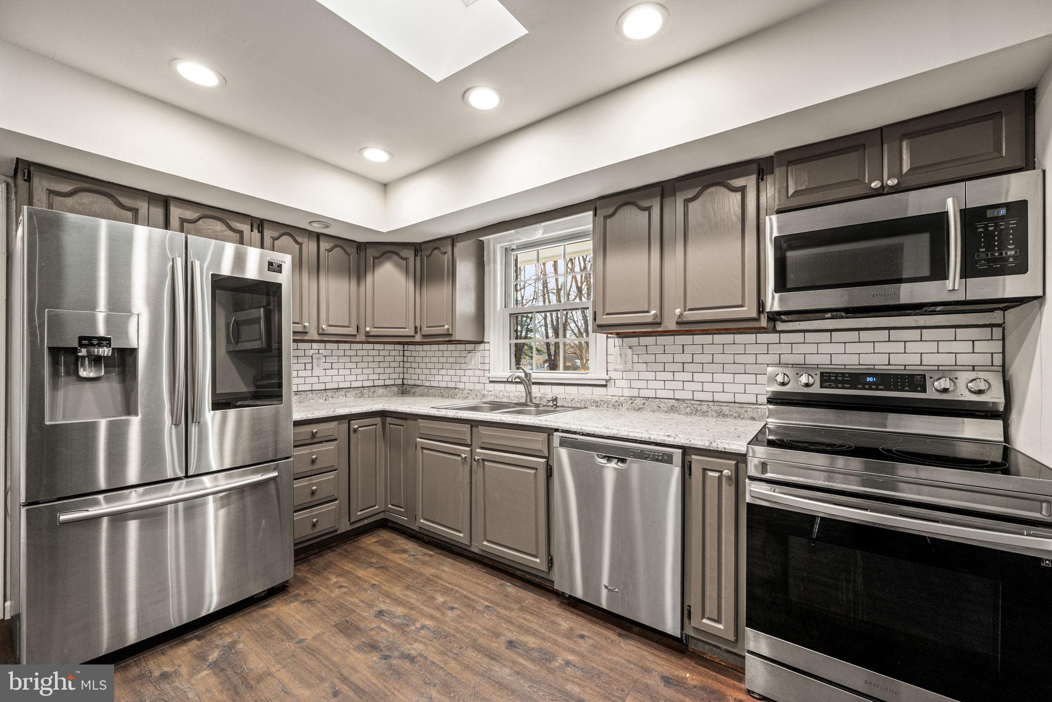 13 Keller Road Cochranville, PA 19330 - Photo 19 of 41 a kitchen with stainless steel appliances granite countertop a stove microwave and refrigerator