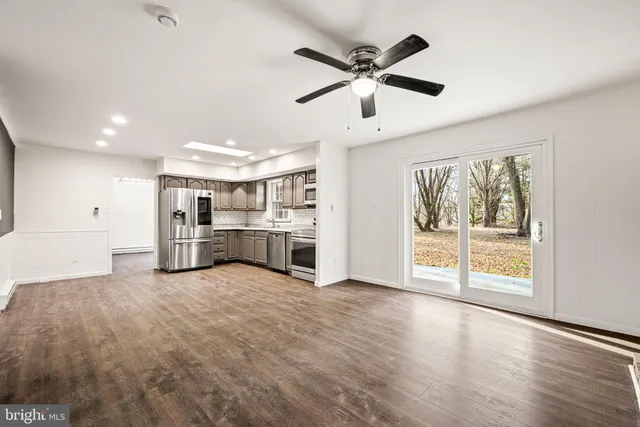 a view of a kitchen with a stove cabinets and a large window