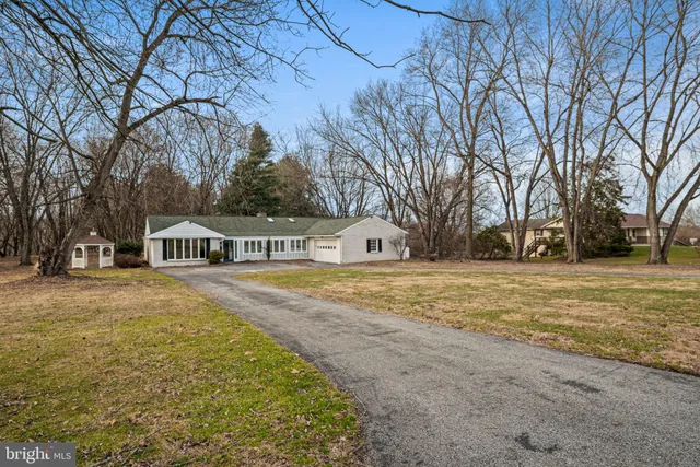a front view of house with yard and trees