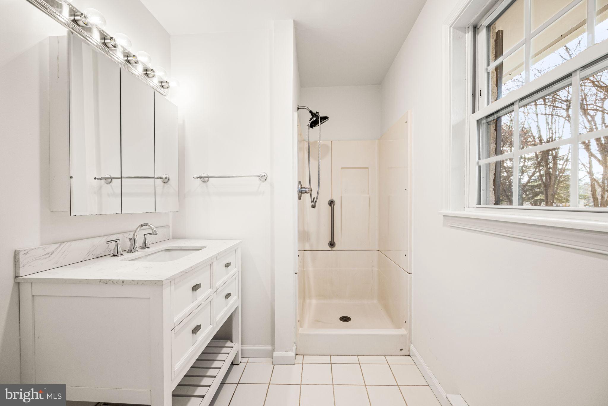 13 Keller Road Cochranville, PA 19330 - Photo 27 of 41 a bathroom with a granite countertop sink a mirror and a shower