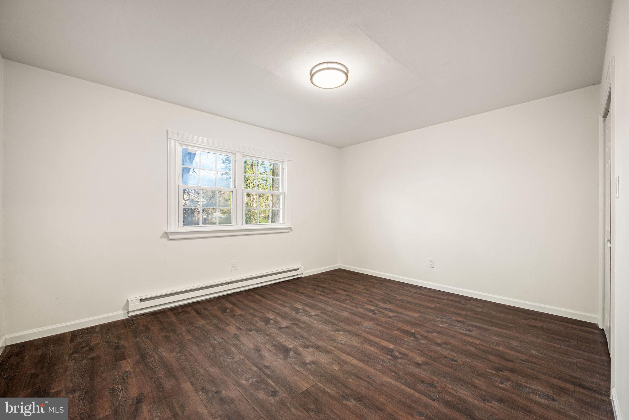 13 Keller Road Cochranville, PA 19330 - Photo 28 of 41 an empty room with wooden floor and windows