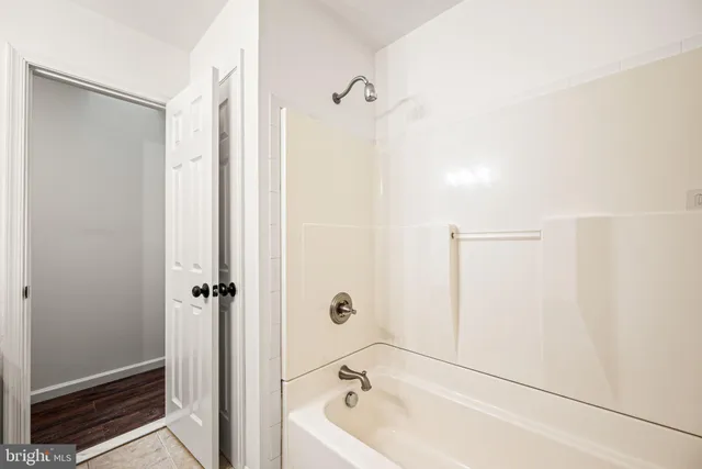 a bathroom with a tub and shower