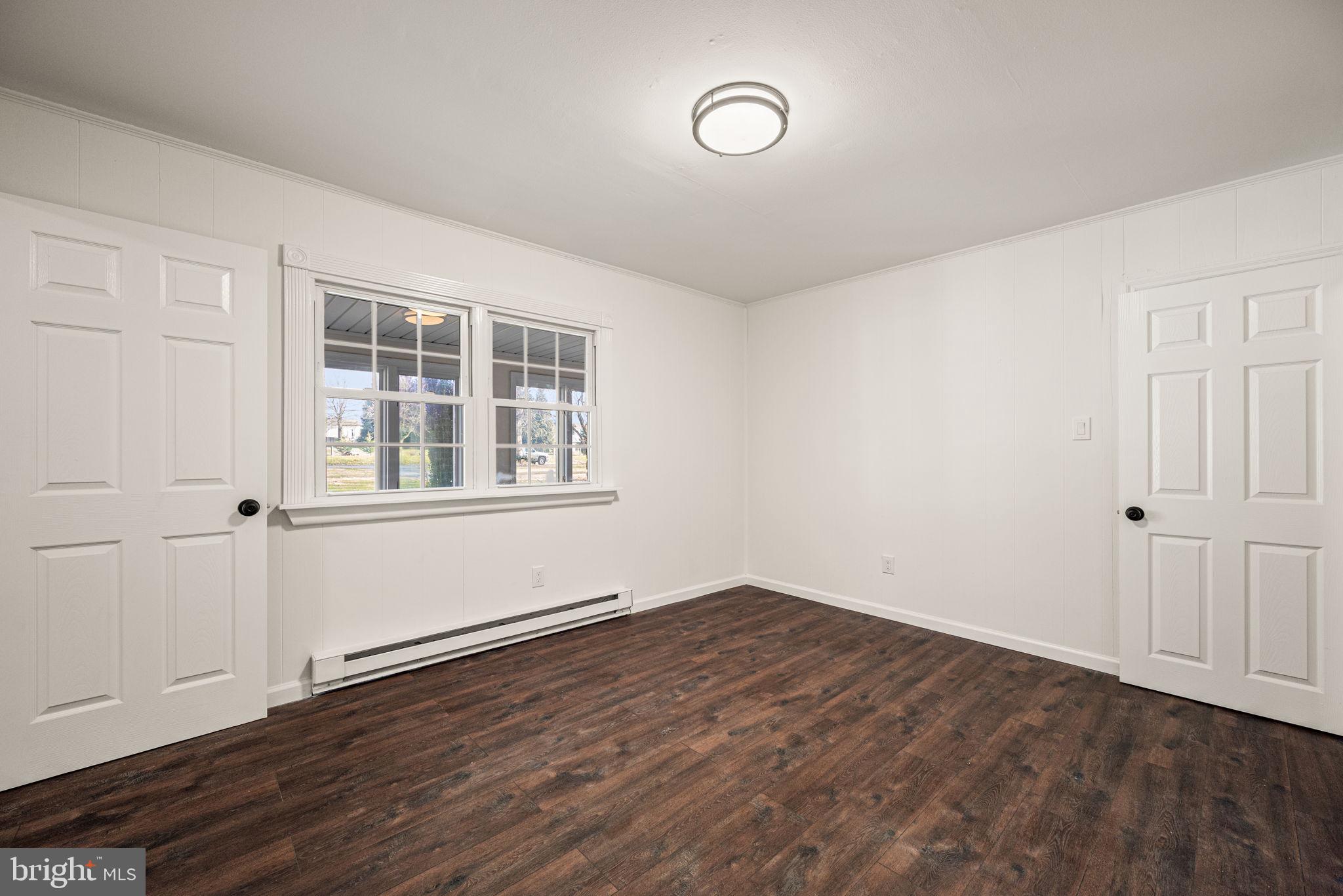 13 Keller Road Cochranville, PA 19330 - Photo 32 of 41 an empty room with wooden floor and windows