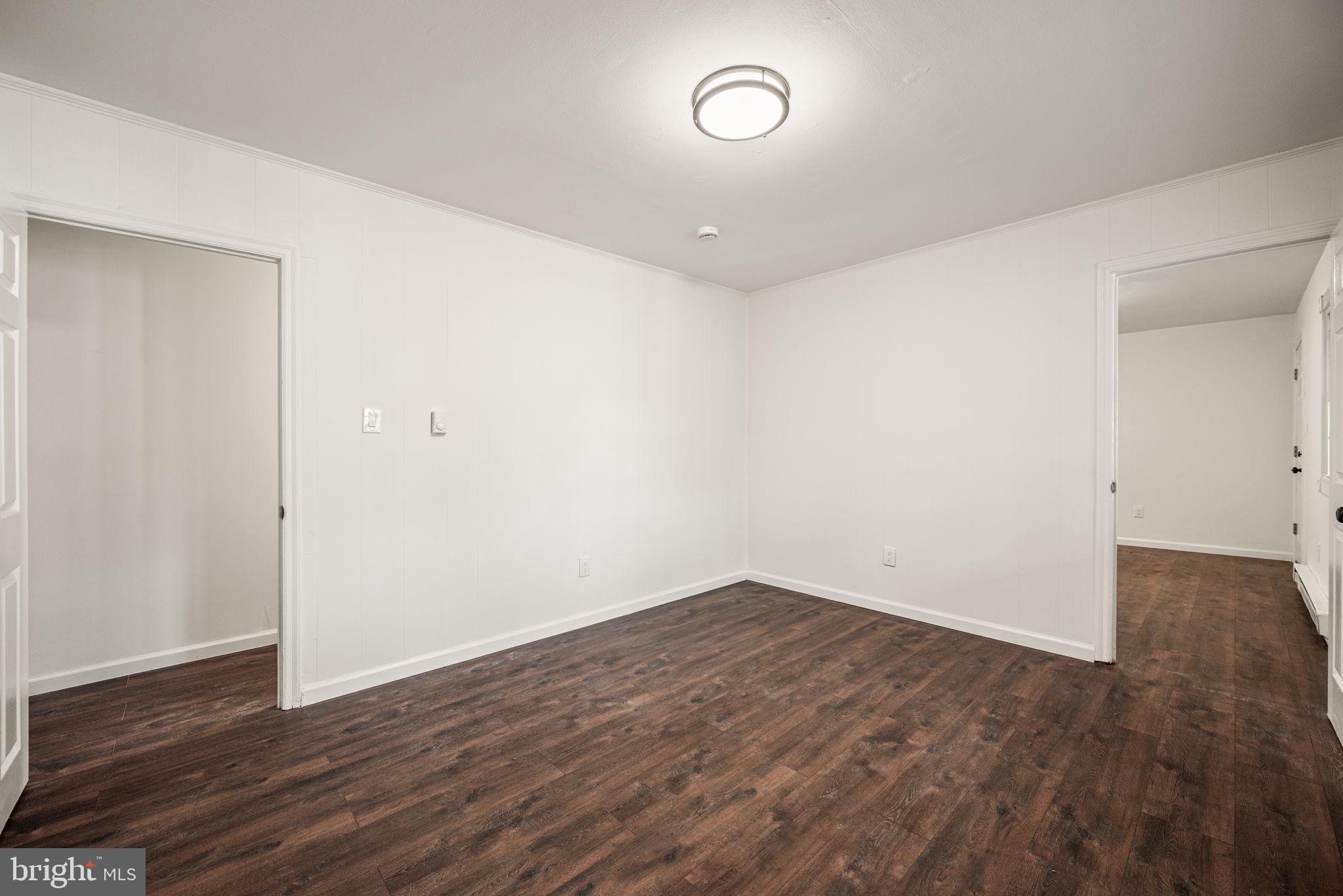 13 Keller Road Cochranville, PA 19330 - Photo 33 of 41 an empty room with wooden floor and windows
