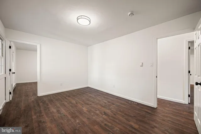 an empty room with wooden floor