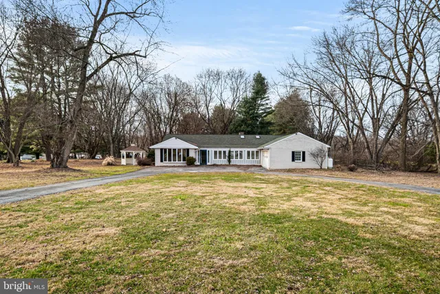 a front view of a house with a yard outdoor seating and yard in the back