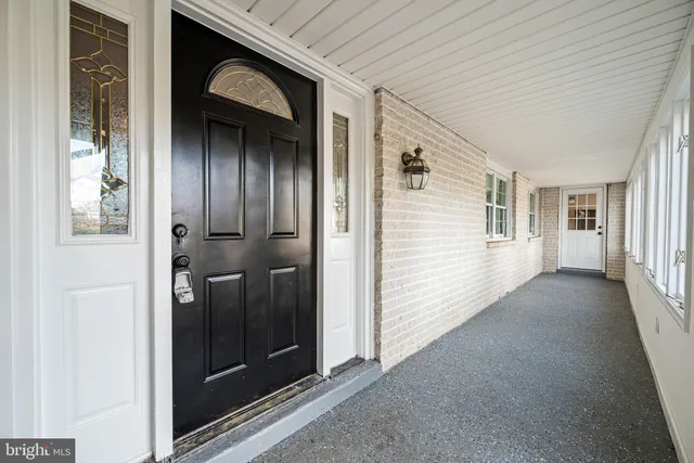 a view of a hallway with wooden shelves