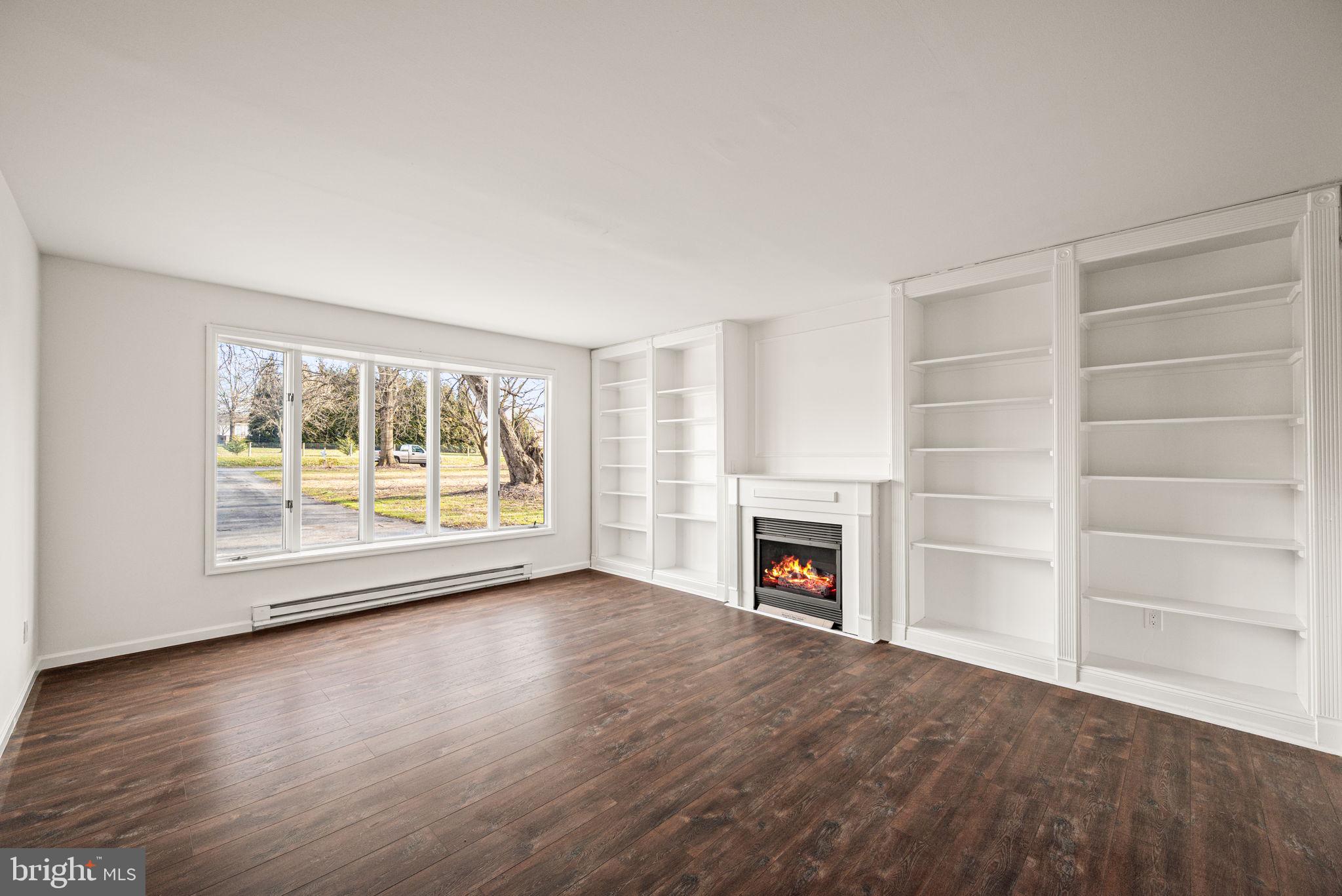 13 Keller Road Cochranville, PA 19330 - Photo 8 of 41 an empty room with furniture a fireplace and wooden floor