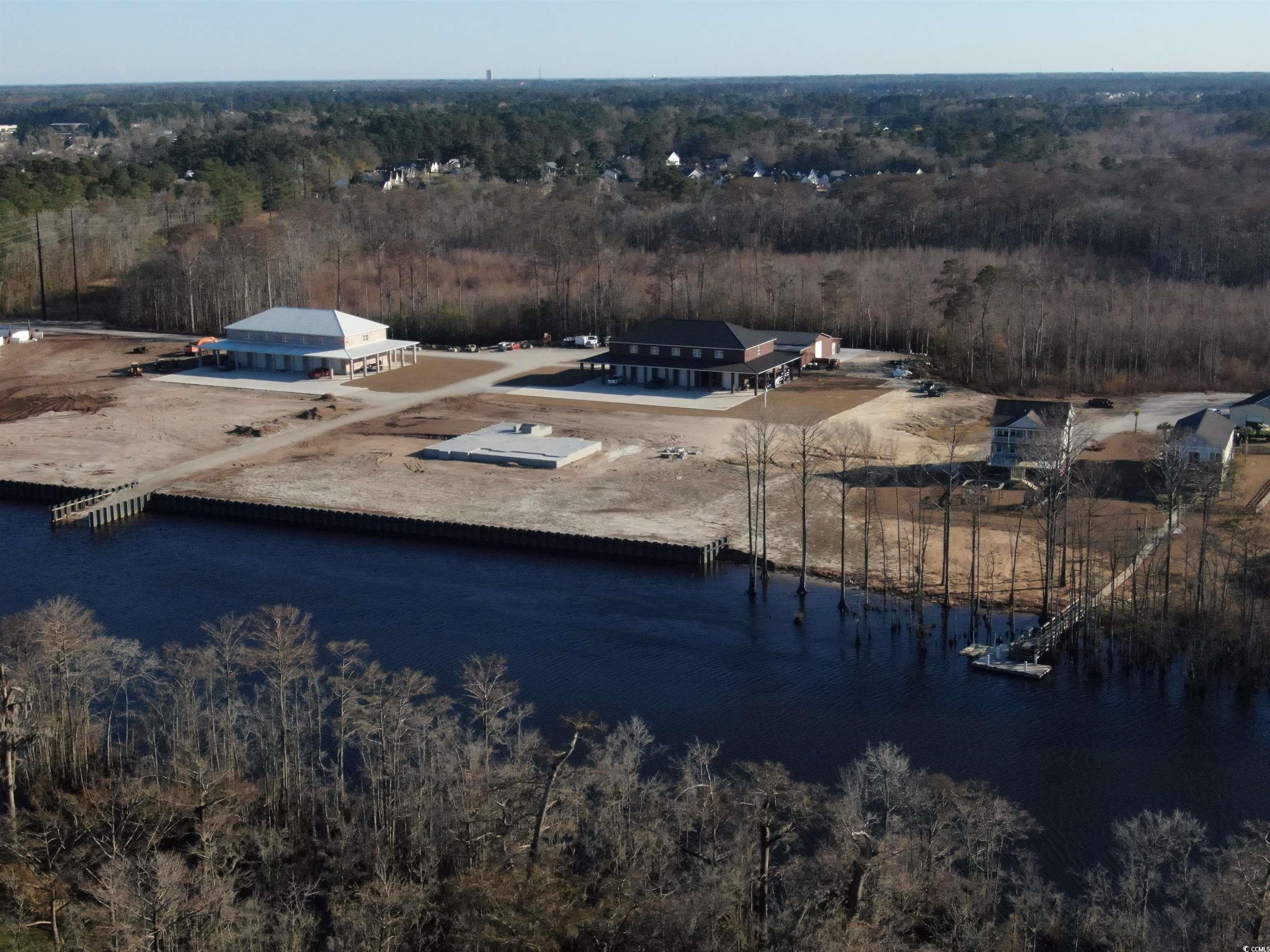 Birds eye view of property with a water view