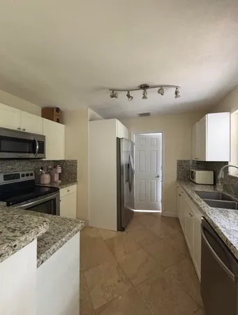 a kitchen with a stove and a refrigerator