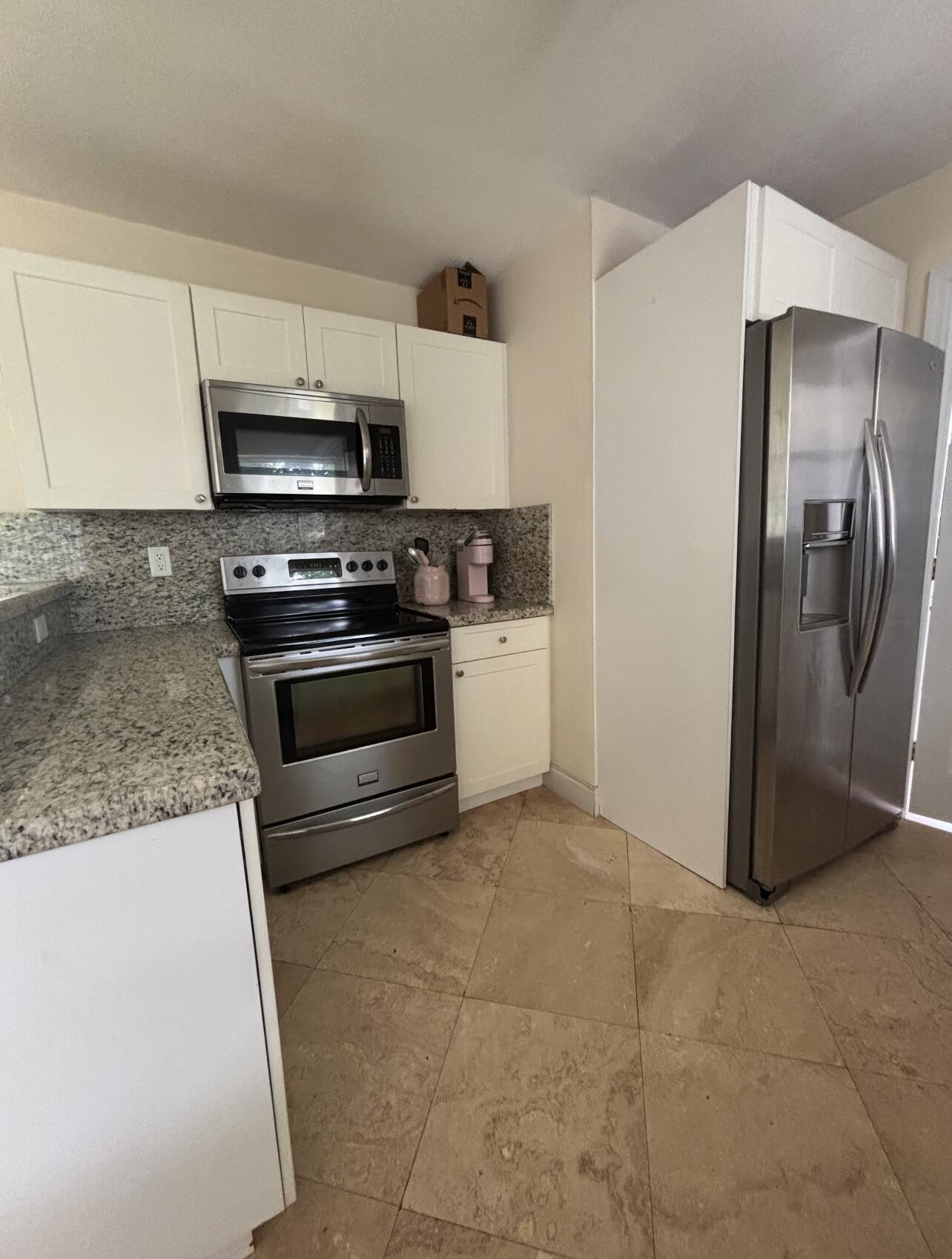 927 West Royal Palm Road Boca Raton, FL 33486 - Photo 13 of 31 a kitchen with stainless steel appliances granite countertop a refrigerator a stove and a sink