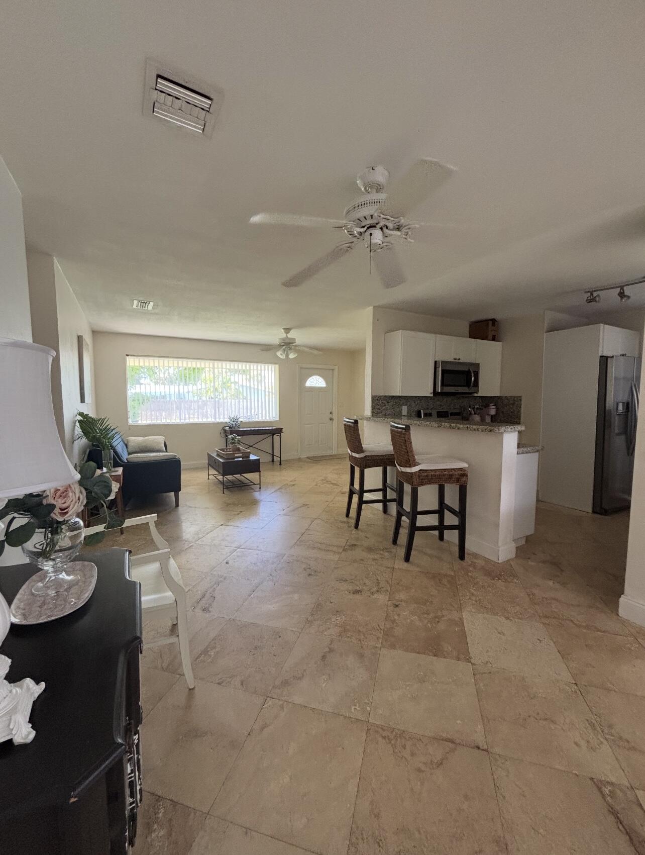 927 West Royal Palm Road Boca Raton, FL 33486 - Photo 14 of 31 a living room with furniture and a dining table with kitchen view