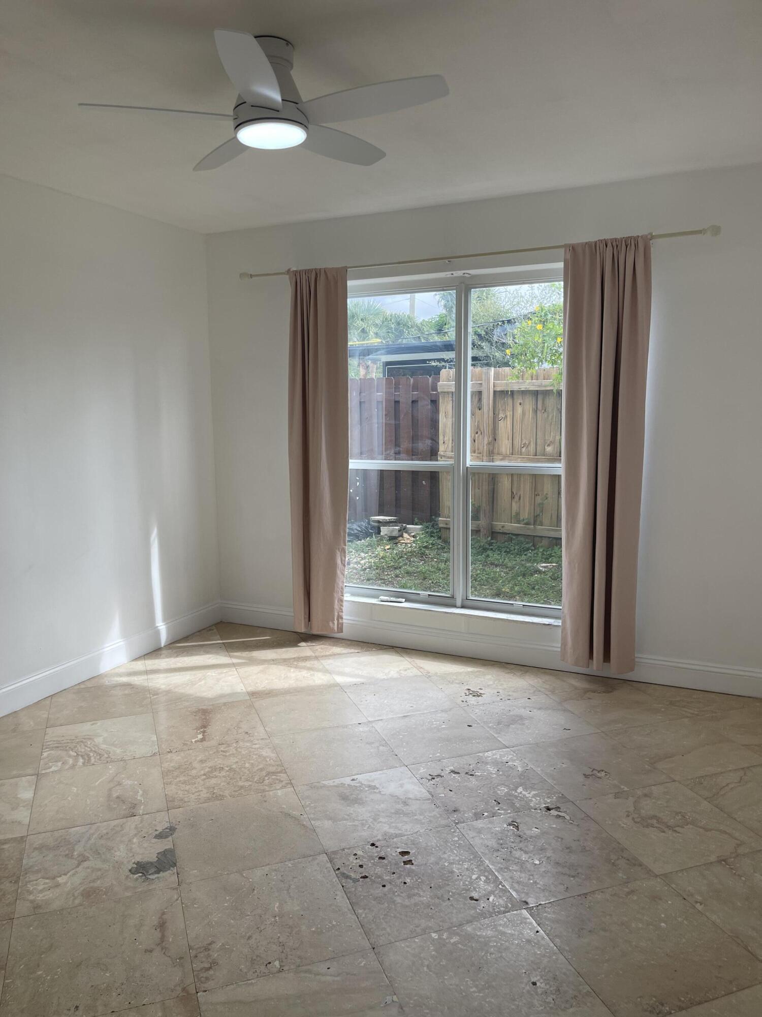 927 West Royal Palm Road Boca Raton, FL 33486 - Photo 20 of 31 a view of empty room with wooden floor and fan