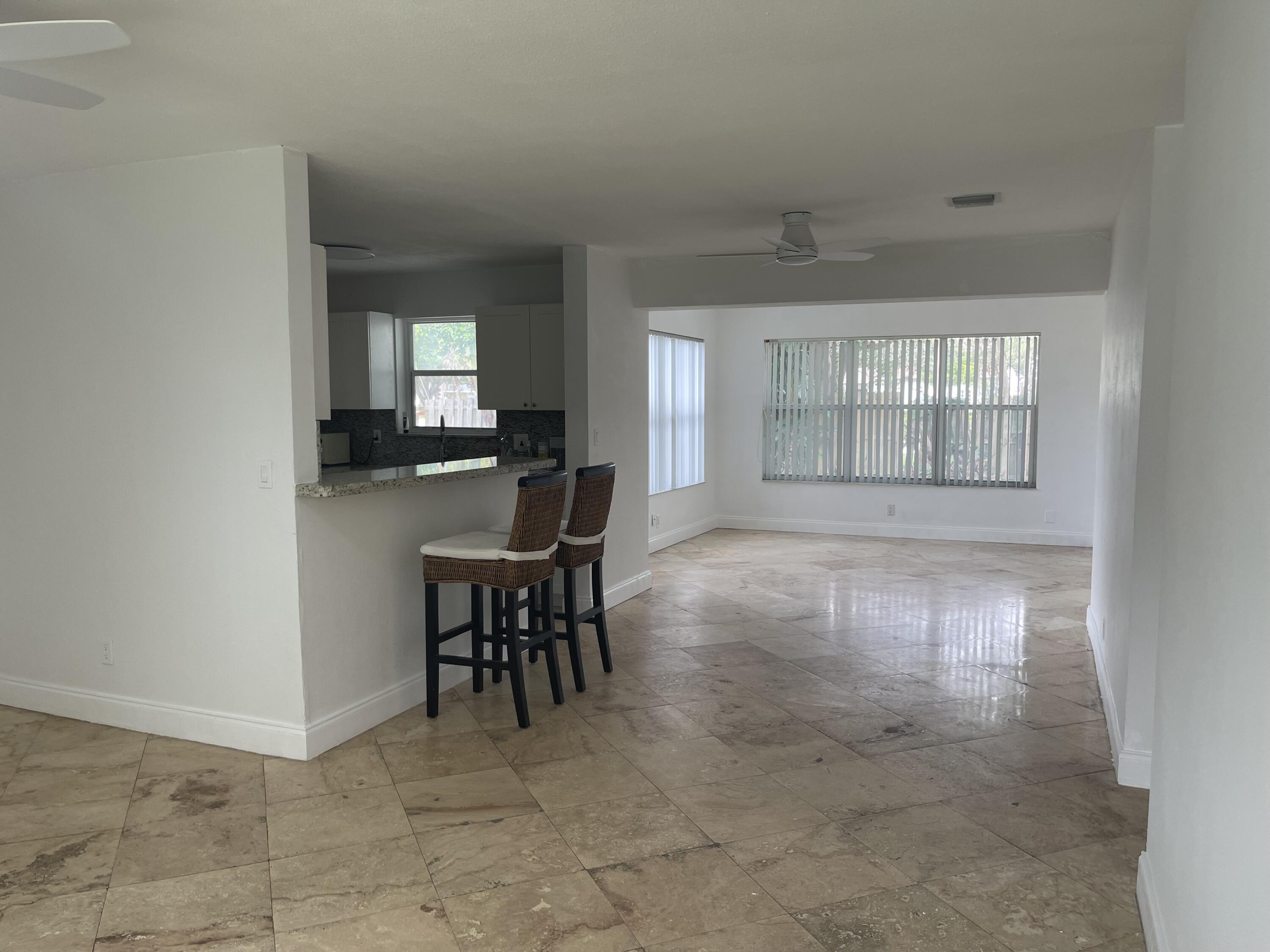 927 West Royal Palm Road Boca Raton, FL 33486 - Photo 4 of 31 a view of a dining room with furniture and chandelier