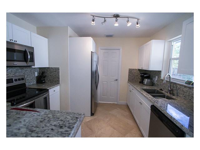 927 West Royal Palm Road Boca Raton, FL 33486 - Photo 10 of 31 a kitchen with stainless steel appliances kitchen island granite countertop a refrigerator and a stove top oven