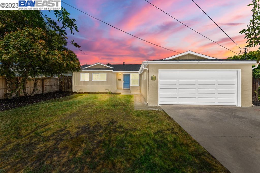 a front view of a house with a garden and yard