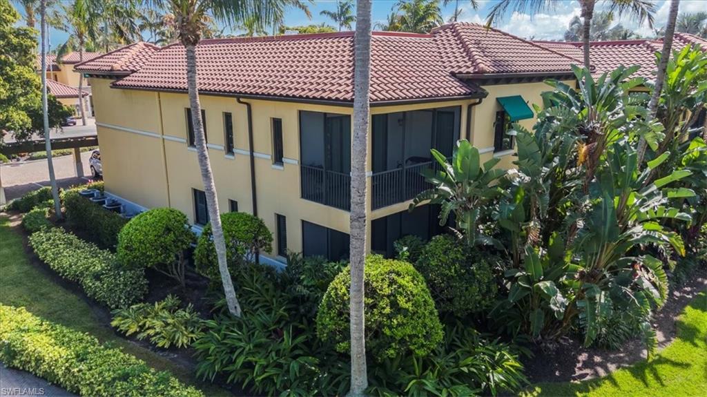 965 Sandpiper Street, Unit J107 Naples, FL 34102 - Photo 1 of 30 a view of a house with plants and trees