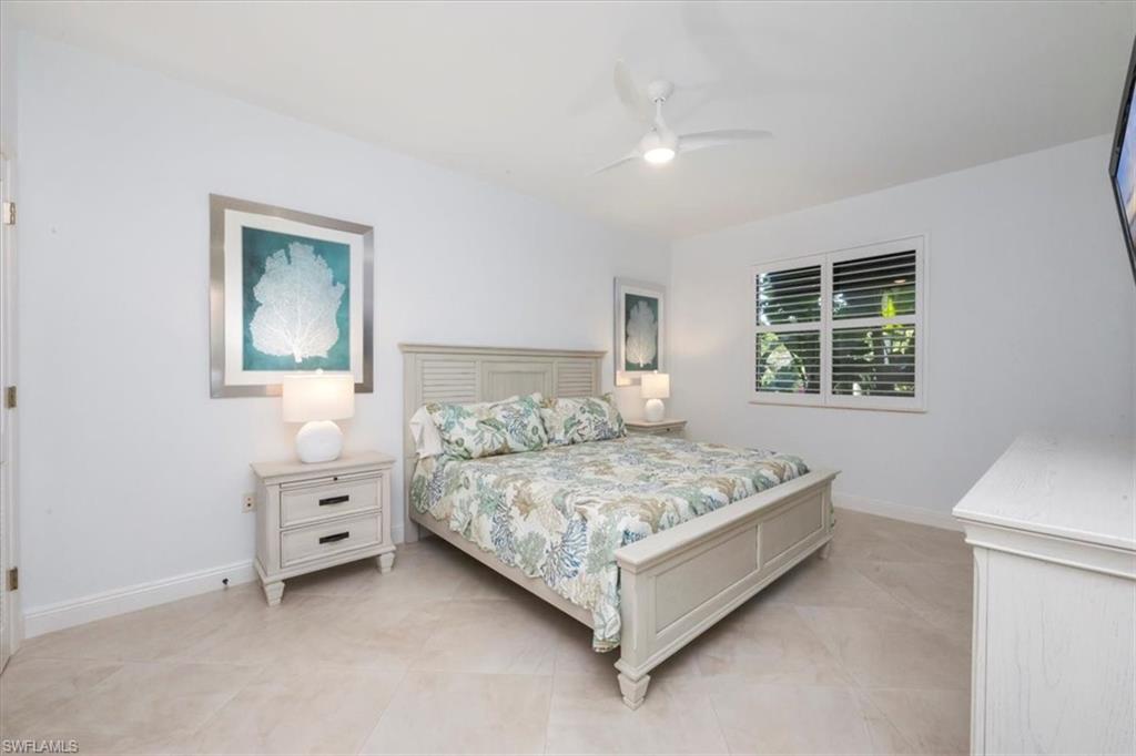 965 Sandpiper Street, Unit J107 Naples, FL 34102 - Photo 10 of 30 a bedroom with a bed and a window