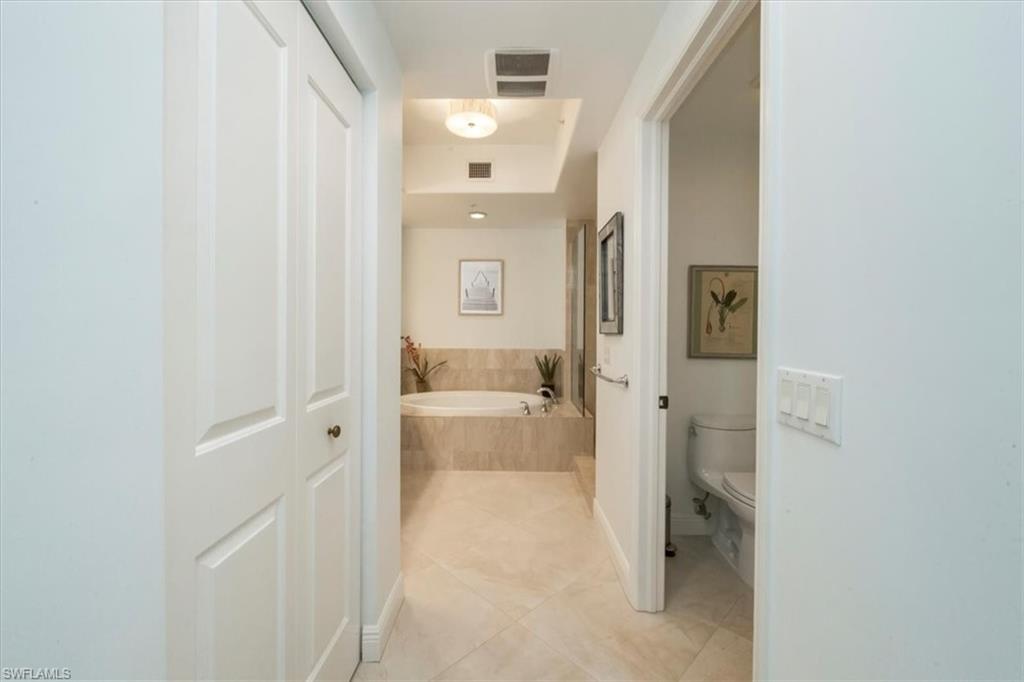 965 Sandpiper Street, Unit J107 Naples, FL 34102 - Photo 11 of 30 a bathroom with a granite countertop sink and a mirror