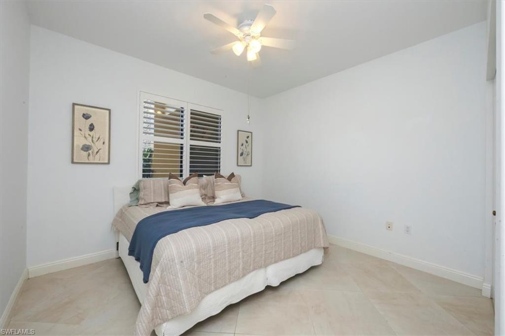 965 Sandpiper Street, Unit J107 Naples, FL 34102 - Photo 15 of 30 a bedroom with a bed and a window