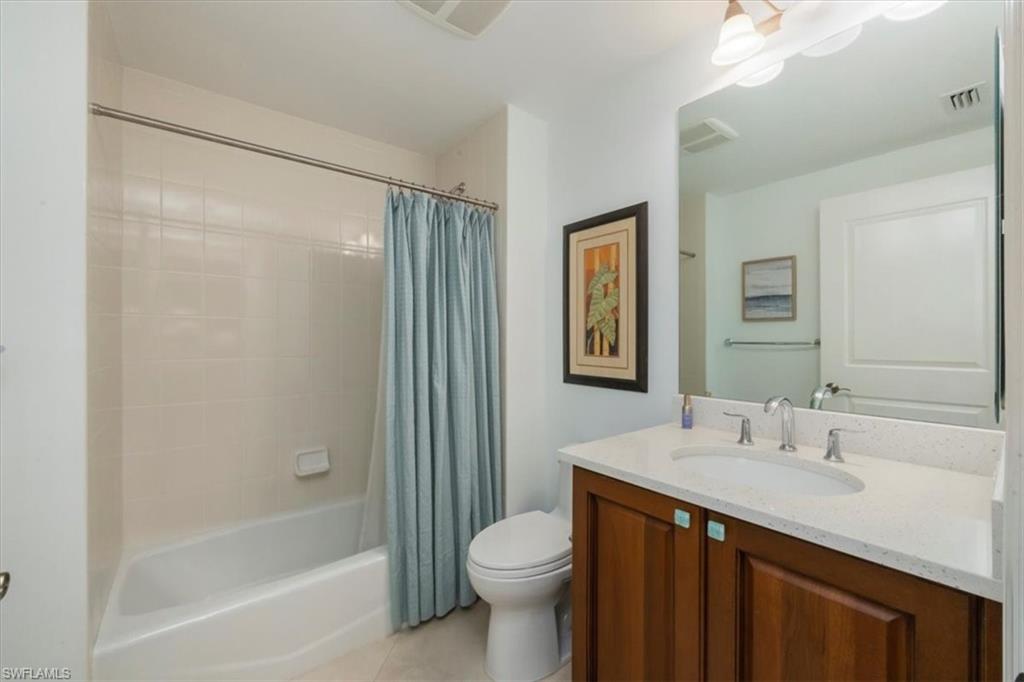 965 Sandpiper Street, Unit J107 Naples, FL 34102 - Photo 16 of 30 a bathroom with a sink a toilet and shower
