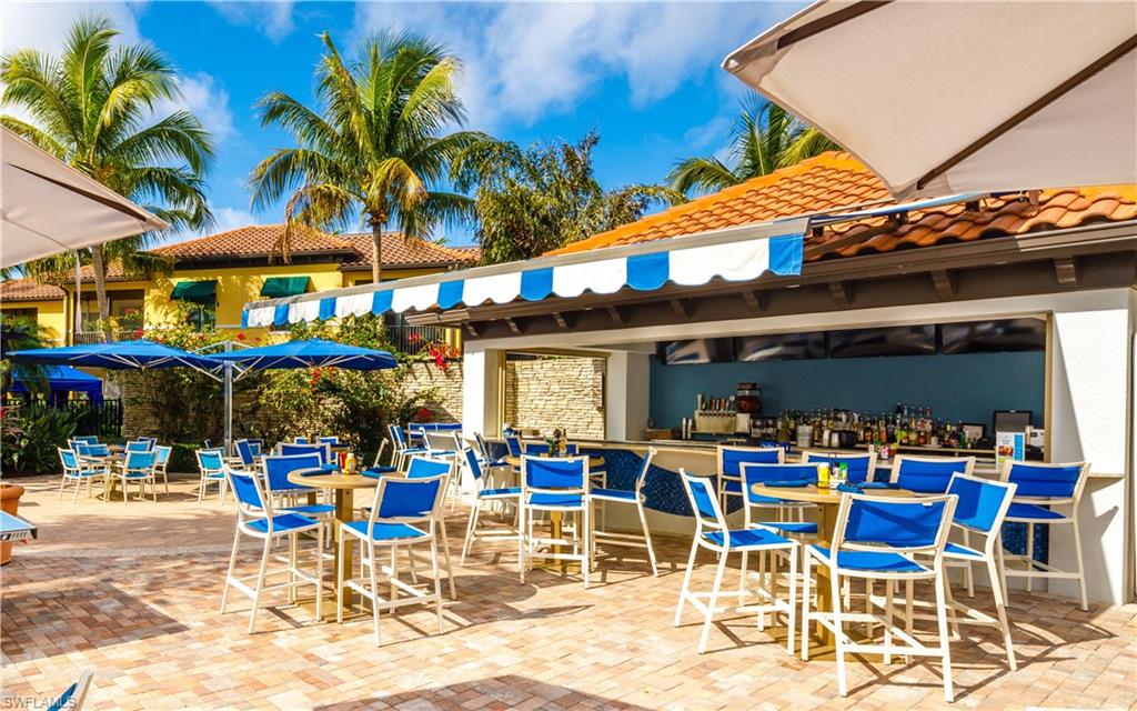 965 Sandpiper Street, Unit J107 Naples, FL 34102 - Photo 24 of 30 a view of a cafe with a table and chairs in patio
