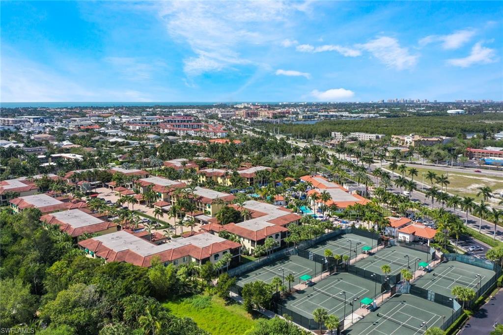 965 Sandpiper Street, Unit J107 Naples, FL 34102 - Photo 25 of 30 an aerial view of residential houses with outdoor space