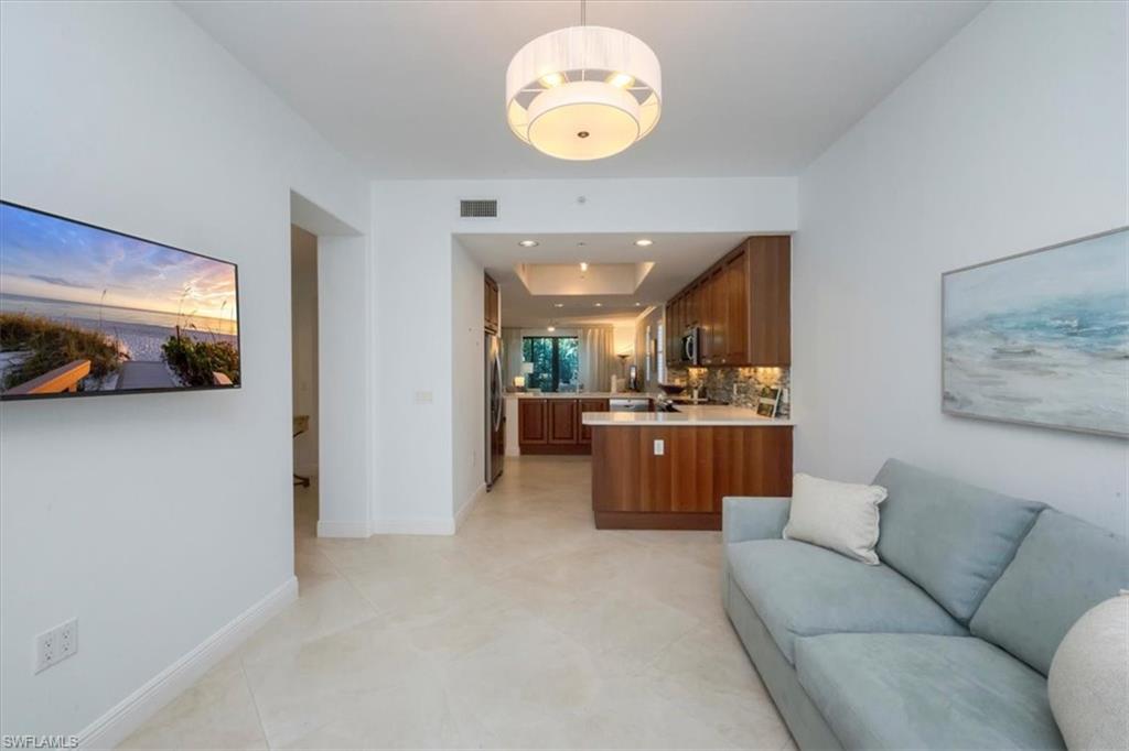 965 Sandpiper Street, Unit J107 Naples, FL 34102 - Photo 5 of 30 a view of a living room and a kitchen