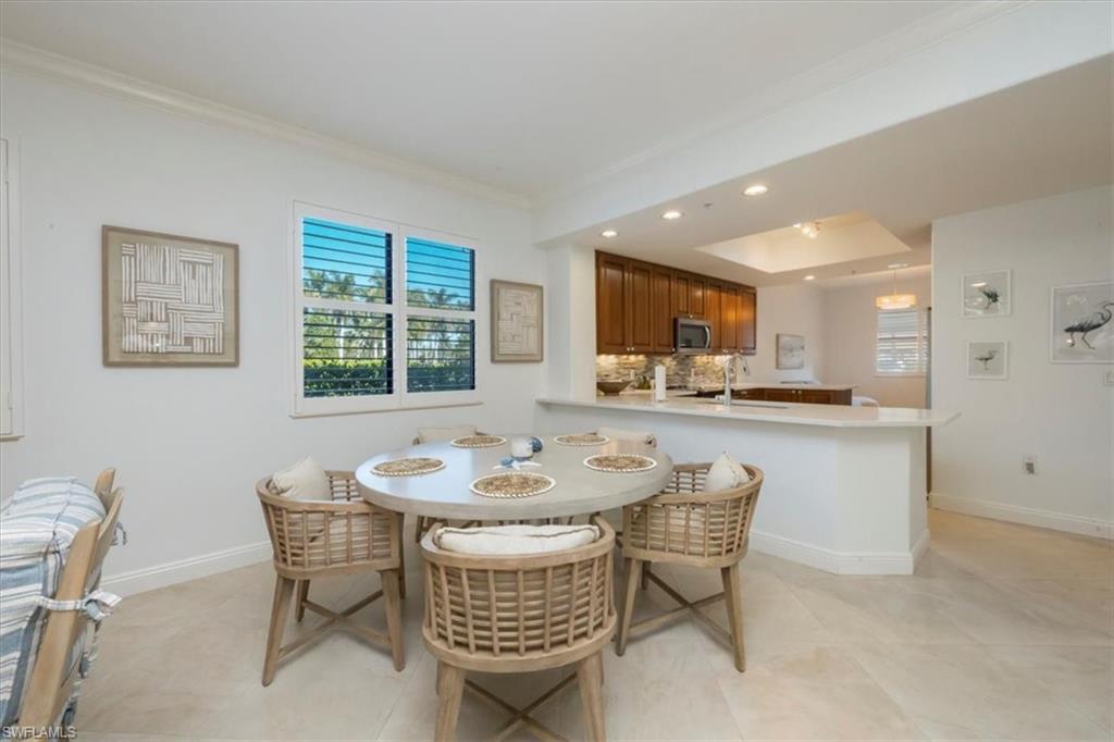 965 Sandpiper Street, Unit J107 Naples, FL 34102 - Photo 6 of 30 a dining room with furniture and window