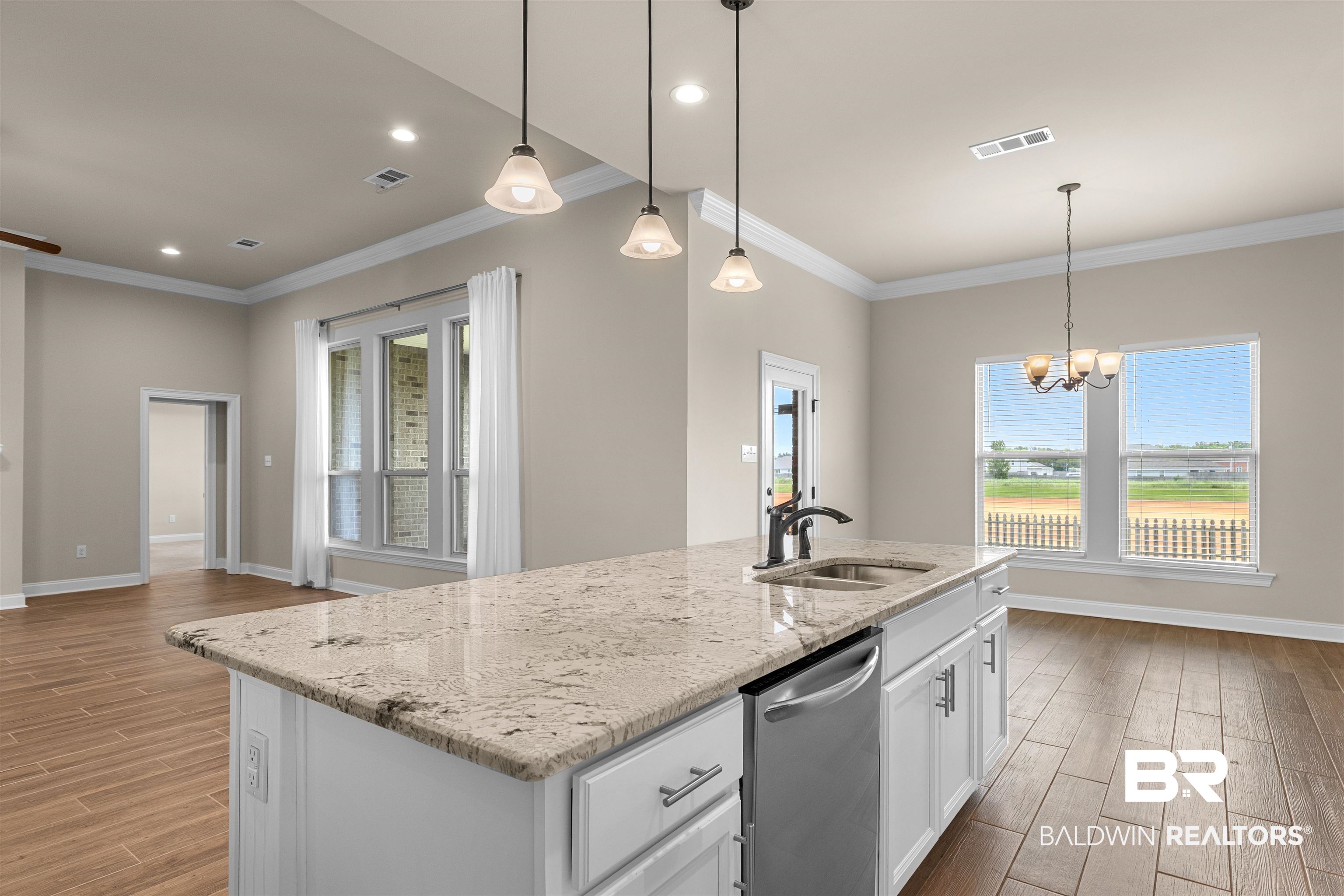 991 Dalton Circle Foley, AL 36535 - Photo 8 of 35 Kitchen featuring dishwasher, light wood-style floors, ornamental molding, white cabinets, and light stone counters